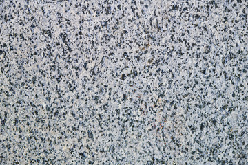 The textured grey marble chips wall, background