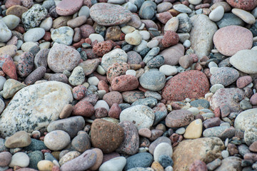 rock covered beach in countryside in Latvia, large rocks in water