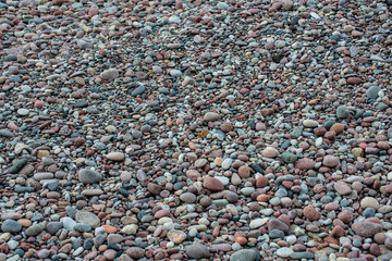 rock covered beach in countryside in Latvia, large rocks in water