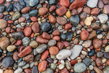 rock covered beach in countryside in Latvia, large rocks in water