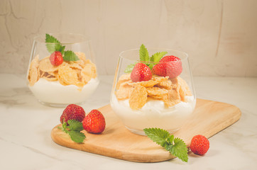 Glass of tasty strawberry dessert/two glass of tasty strawberry dessert on wooden tray, selective focus