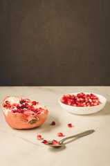 grenades fruit, seeds of pomegranate in a white bowl/grenades fruit, purified red seeds of pomegranate in a white bowl