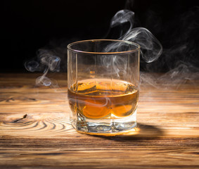 Glass of whiskey and smoke.