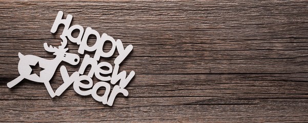 Inscription Happy New Year on wooden background.