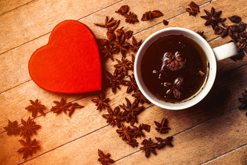 Christmas star anise tea and gift box on wooden background