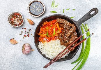 Beef with basmati rice and vegetables-carrots, bell peppers, onions and garlic. Spices and sesame soy sauce.  Asian dishes. Selective focus