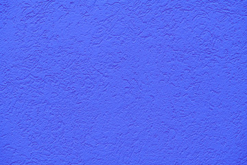 Fototapeta premium The texture of plastered deep or medium blue wall, background
