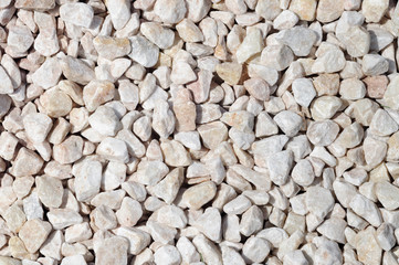 Small decorative limestone stones of light beige tone.
