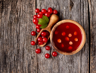 Viburnum oculus. Guelder rose on wooden background.Viburnum berries in wooden scoop.Viburnum souce