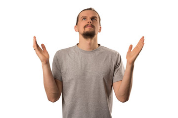 Naklejka premium Bearded attractive caucasian guy spread his hands up isolated on white