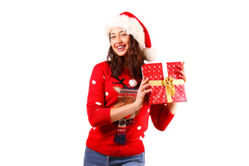 Beautiful smiling young woman wearing knitted sweater celebrating Christmas. Attractive brunette casual female, new years eve. Ugly Christmas sweater concept. Background, copy space, close up portrait