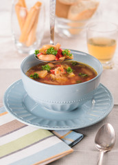 soup with meat, carrots, beans  and parsley in a restaurant on a beautifully served table