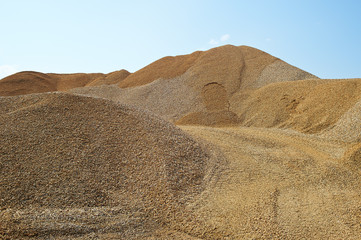 Heaps of sand or macadame and road in a quarry