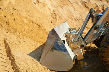 An excavator or digger uses ladle working with sand