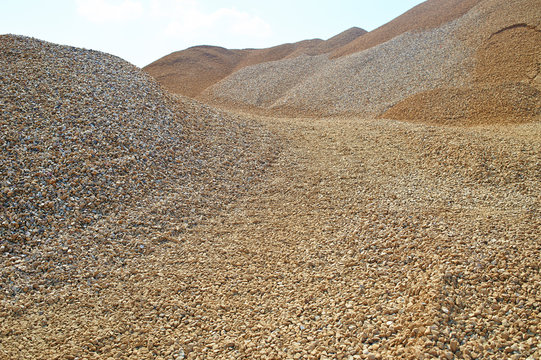 Heaps of sand or macadame and road in a quarry