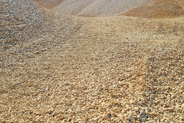 Heaps of sand or macadame and road in a quarry