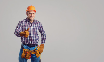 Repairman smiling in special clothes with tools.