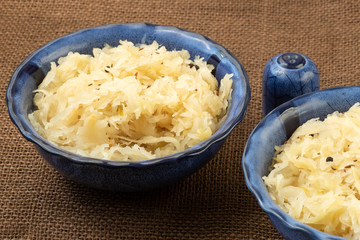 Sauerkraut in a blue bowl. Fresh healthy sauerkraut.