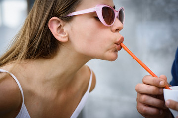 Thirsty for a drink. Cute woman drink through straw. Pretty woman sip beverage with drinking straw. Fashionable woman enjoy sipping drink through straw