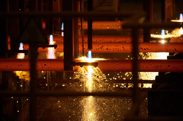Iron factory with hot candent block of iron or steel or zinc in process of production or cooling