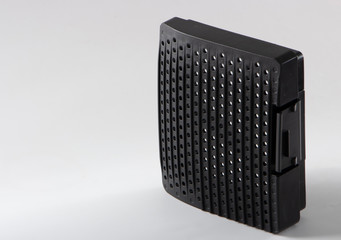 Black lid covering the compartment with a filter at the vacuum cleaner