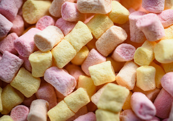 Gummy and fluffy. Marshmallow souffle with sweet flavor. Marshmallow recipe with sugar and gelatin. Sweet snack food. Unhealthy junk food. Colorful mini marshmallow background or texture