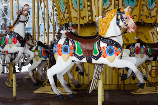 Carousel with rocking horses in the park. Children's carousel is closed for the winter season. horses