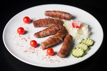 white plate with kebabs isolated on dark background. kebab isolated
