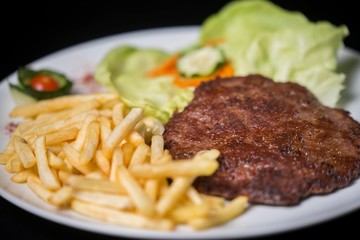 hamburger with french fries isolated on plate.