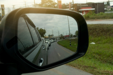 Cars traffic jam on the road view from mirror side of car.