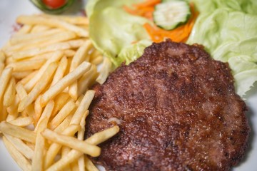 hamburger with french fries isolated on plate.