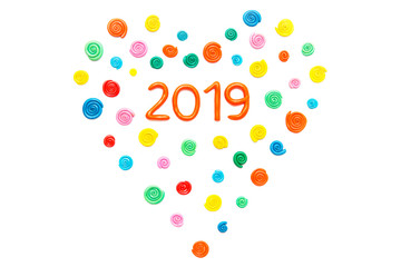 Plasticine circle in the shape of heart with numerals 2019 on white background. Isolated on white