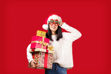 Beautiful smiling asian woman wearing knitted sweater celebrating Christmas. Portrait of attractive brunette casual female at new years eve. Background, copy space, close up.