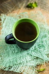 Tea in the mug on the green grid,table cloth