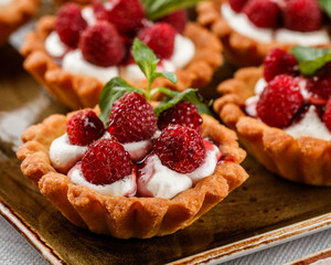 Fruit tart with raspberries and cream, cakes and sweetness on holiday background. Delicious dessert and candy bar. - obrazy, fototapety, plakaty