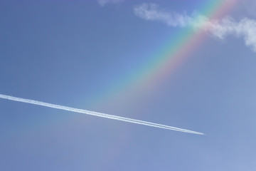 Beautiful blue sky, rainbow and small plane