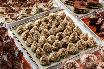 Candy with chocolate, nuts and coconut, cakes and sweetness on holiday background. Delicious dessert and candy bar