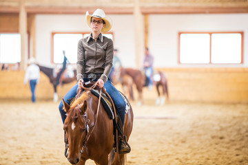 Cowgirl person riding horse in arena