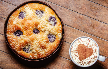Christmas pie and cup of coffee with heart shape on wooden table. Hight angle point of view