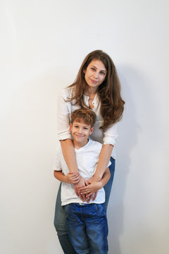 Mother And Preteen Son Posing On White Background