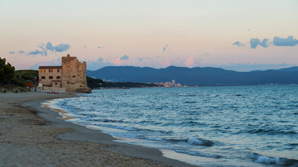 Torre Mozza, Piombino, Toscana, Italy — 16 June 2018. View on the sea, beach and ancient fortress at sunset