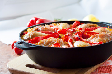 Chicken thighs and legs baked over a bed of rice and red bell pepper
