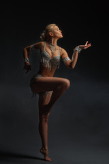 Fototapeta na wymiar Slender girl blonde in a beautiful costume dancing Oriental dance.