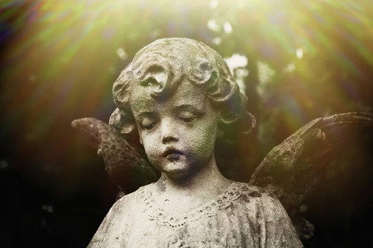 Ancient statue of sad angel of death as symbol of the end of life.
