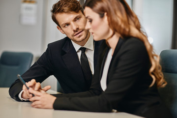 A couple of bussinessmen and bussines woman discussing an important topic
