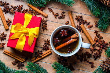 Obraz na płótnie Canvas Cup of tea with star anise and cinnamon around Christmas decoration