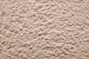 Prominent texture of beige cement wall, background