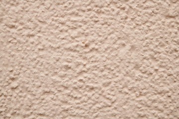 Prominent texture of beige cement wall, background