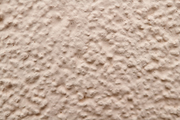 Prominent texture of beige cement wall, background