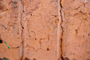 The texture of old red bricks with fissures and fractures, background